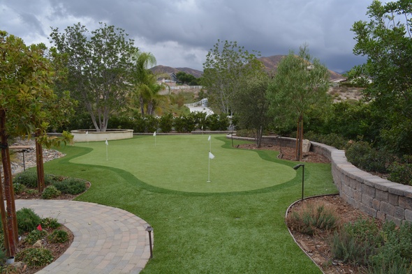 Austin Synthetic grass golf green in a landscaped backyard