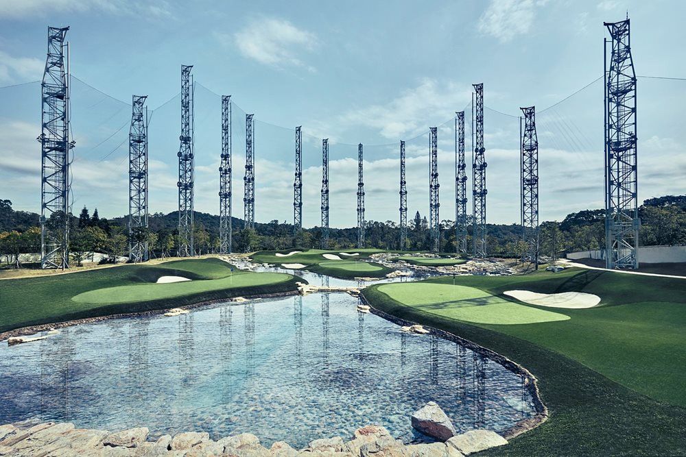 Austin Synthetic grass golf course with water and tall metal towers