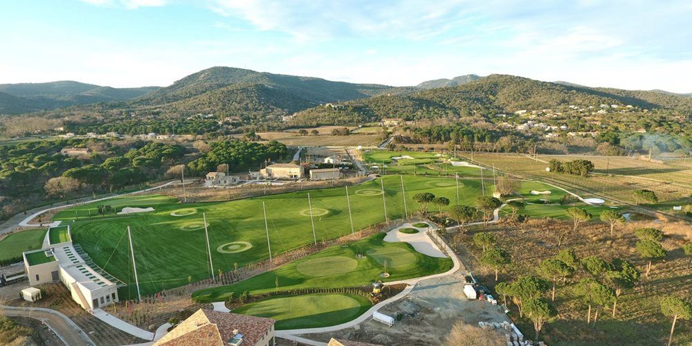 Austin Aerial view of a synthetic grass golf course surrounded by hills